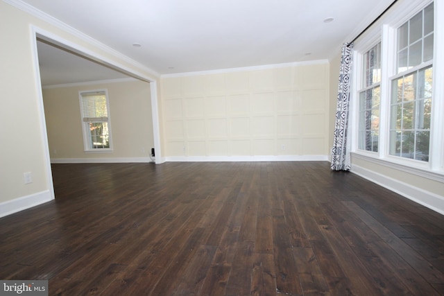 unfurnished room featuring baseboards, dark wood-type flooring, and crown molding