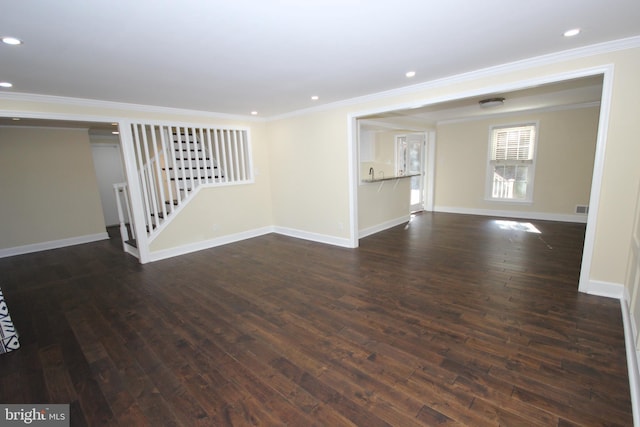 unfurnished living room with baseboards, dark wood finished floors, recessed lighting, ornamental molding, and stairs