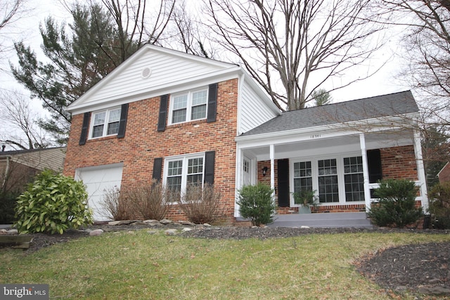 view of front facade with a front yard, a porch, a shingled roof, a garage, and brick siding