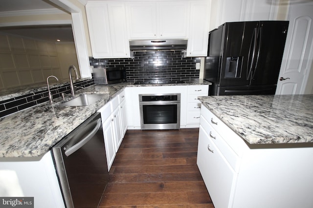 kitchen featuring black appliances, under cabinet range hood, a sink, backsplash, and dark wood-style flooring