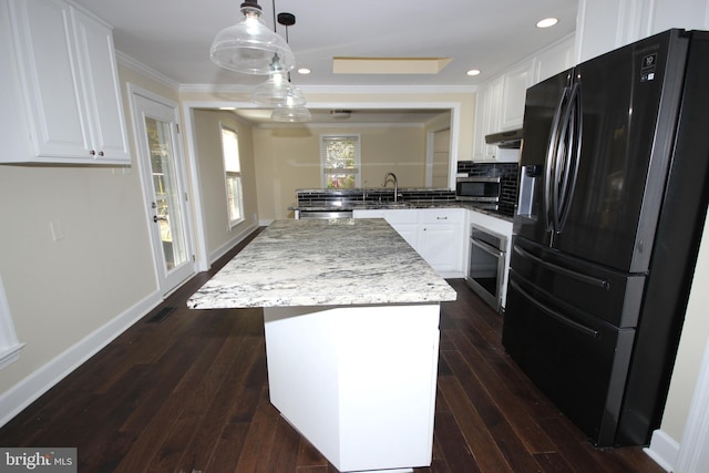 kitchen featuring ornamental molding, appliances with stainless steel finishes, white cabinetry, and dark wood-style flooring