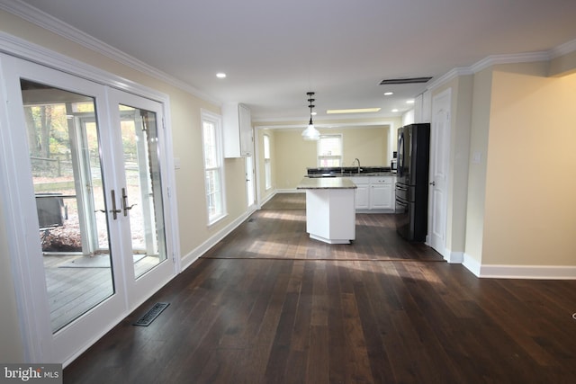 kitchen with crown molding, french doors, freestanding refrigerator, dark wood-style floors, and a sink