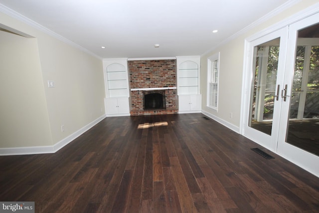 unfurnished living room with visible vents, baseboards, a brick fireplace, and ornamental molding