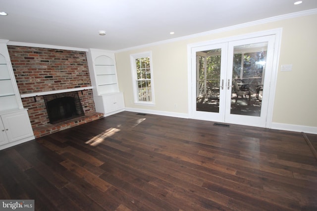 unfurnished living room featuring baseboards, wood finished floors, visible vents, and ornamental molding