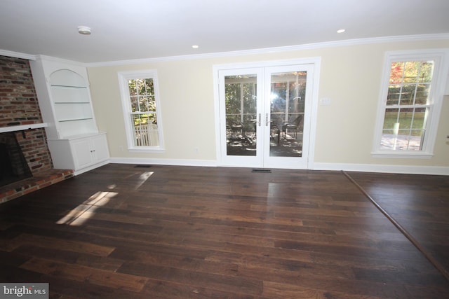 unfurnished living room with a healthy amount of sunlight, wood finished floors, and crown molding