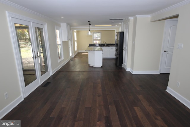 kitchen with dark wood finished floors, french doors, freestanding refrigerator, and ornamental molding