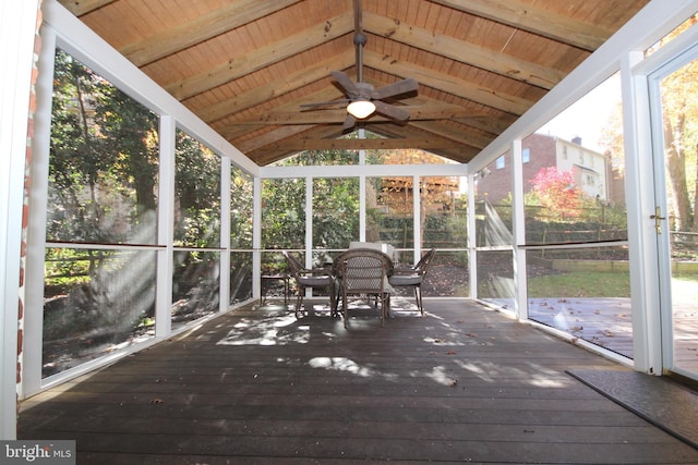 unfurnished sunroom with lofted ceiling with beams, wood ceiling, and ceiling fan