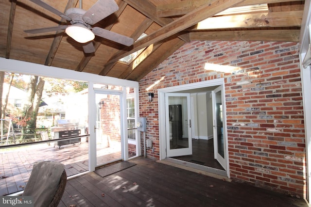 exterior space featuring lofted ceiling with skylight and a ceiling fan