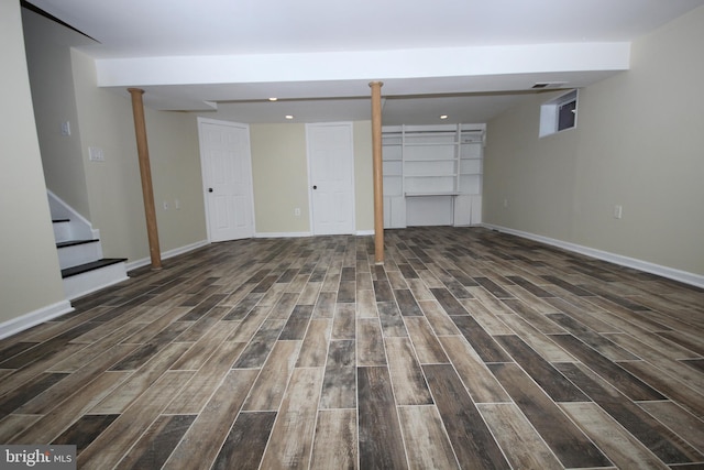 finished below grade area with visible vents, baseboards, wood tiled floor, stairway, and recessed lighting