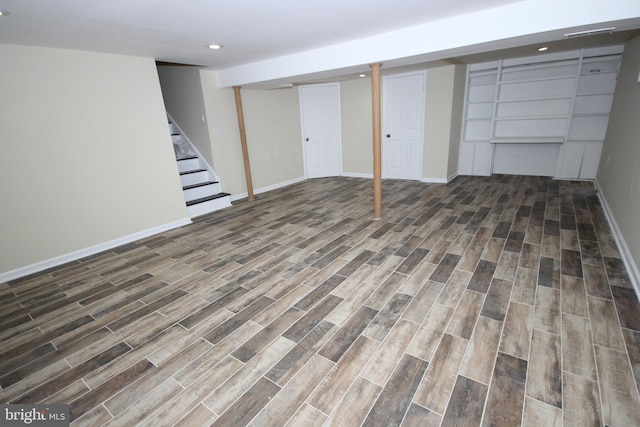 finished below grade area featuring stairway, recessed lighting, baseboards, and wood tiled floor