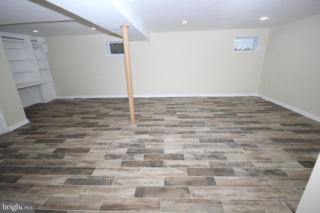 basement with wood finished floors, recessed lighting, and baseboards