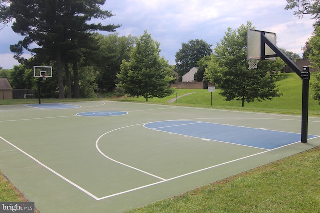 view of basketball court with a yard and community basketball court