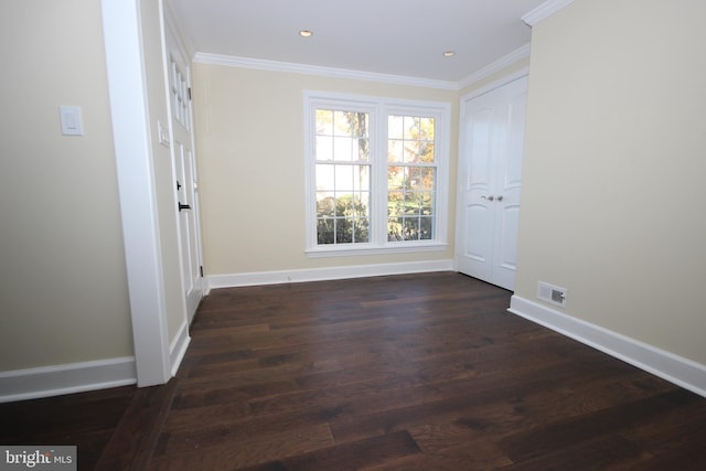 unfurnished room with visible vents, dark wood-type flooring, baseboards, ornamental molding, and recessed lighting