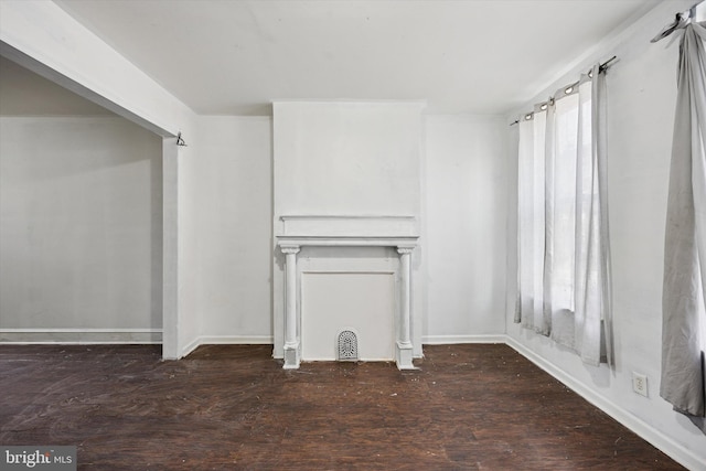 unfurnished living room with wood finished floors