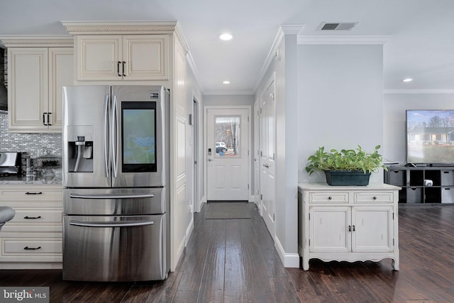 kitchen with visible vents, stainless steel fridge with ice dispenser, light countertops, decorative backsplash, and dark wood-style flooring