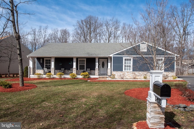 view of front of property featuring stone siding, a porch, a front lawn, and a shingled roof