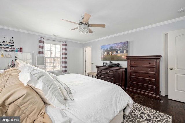 bedroom with hardwood / wood-style floors, visible vents, and ornamental molding