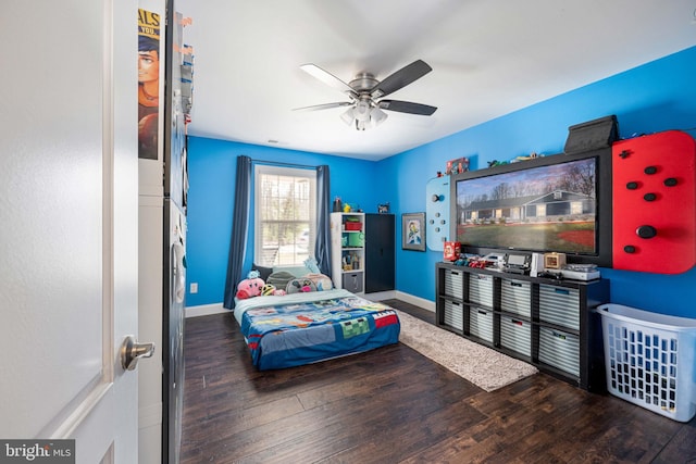 bedroom featuring a ceiling fan, wood finished floors, and baseboards