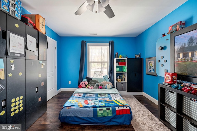 bedroom with visible vents, ceiling fan, baseboards, and wood finished floors