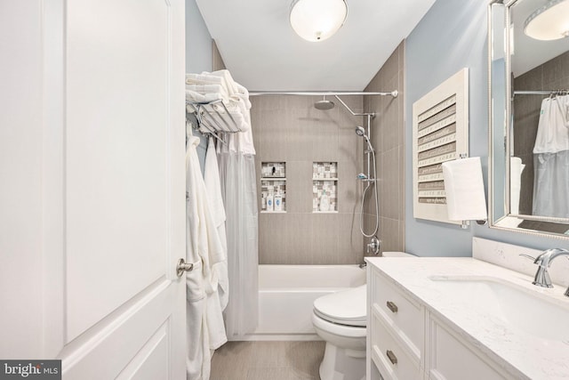 bathroom featuring toilet, shower / bath combo, and vanity