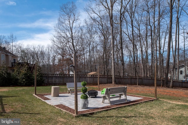 view of yard featuring a patio area, an outdoor fire pit, and a fenced backyard