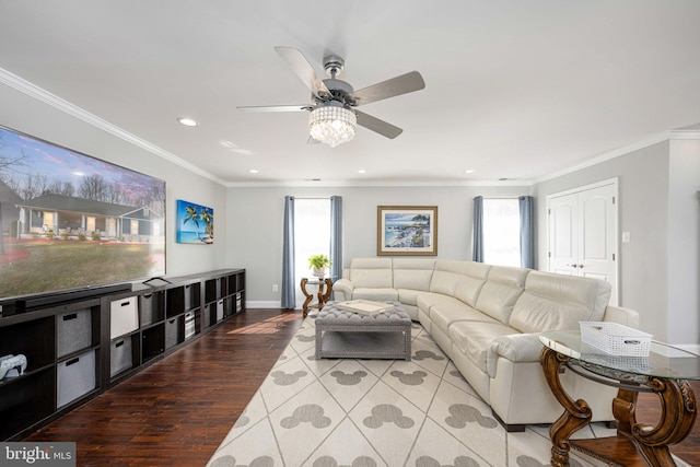 living room with plenty of natural light, wood finished floors, and ornamental molding