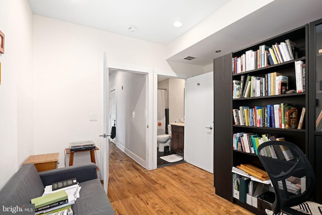 living area featuring light wood finished floors, visible vents, and recessed lighting