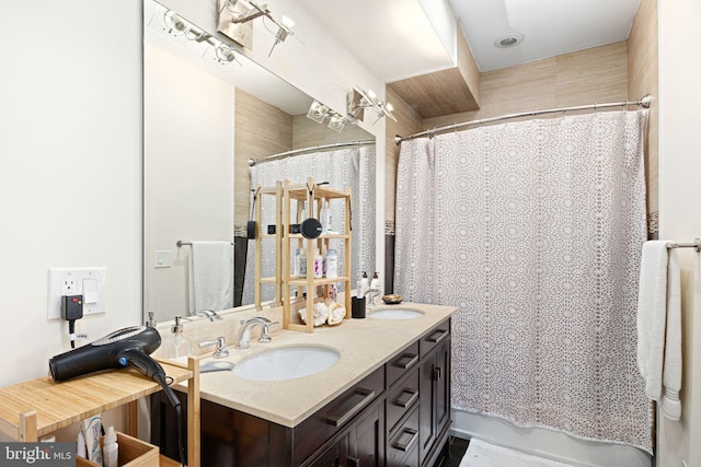 full bathroom with a sink, a shower with curtain, and double vanity