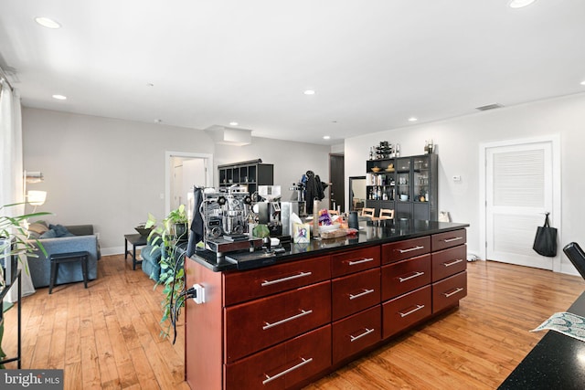 kitchen with recessed lighting, light wood-style floors, visible vents, and reddish brown cabinets