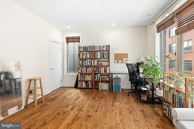 home office with recessed lighting, baseboards, and wood-type flooring