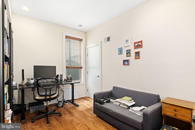 office featuring visible vents, baseboards, and hardwood / wood-style floors