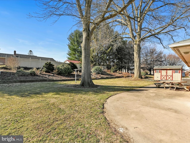 view of yard with an outbuilding and a storage shed