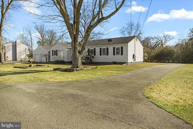 view of front of property featuring a garage and a front yard