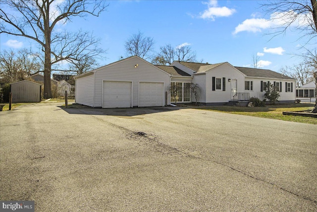 view of front of property with aphalt driveway and a garage