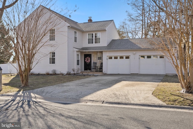 traditional home featuring fence, driveway, an attached garage, a shingled roof, and a chimney