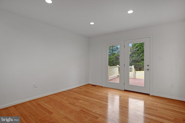 empty room featuring recessed lighting, visible vents, baseboards, and light wood-style flooring