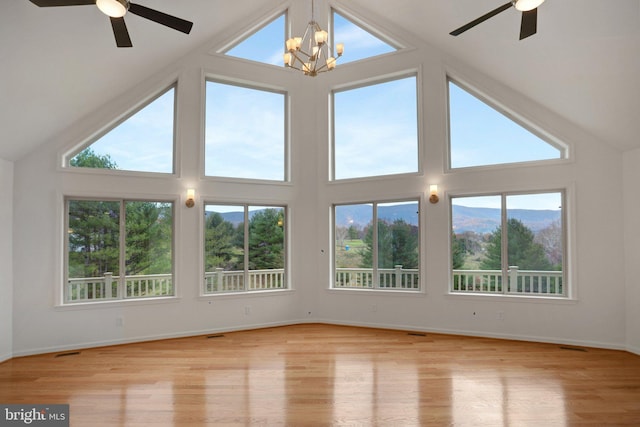 unfurnished sunroom with lofted ceiling and ceiling fan with notable chandelier