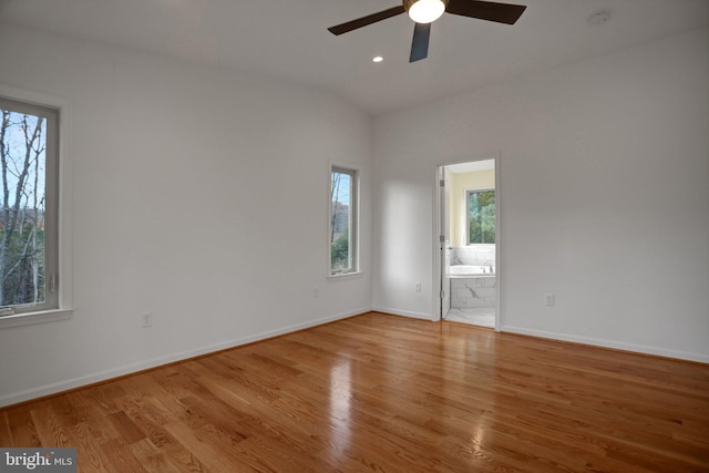 unfurnished room with lofted ceiling, wood finished floors, recessed lighting, baseboards, and ceiling fan