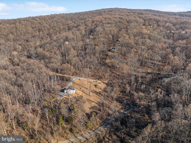 birds eye view of property with a view of trees