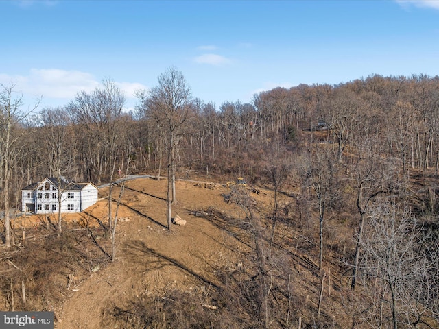 drone / aerial view featuring a forest view