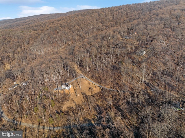 birds eye view of property with a forest view