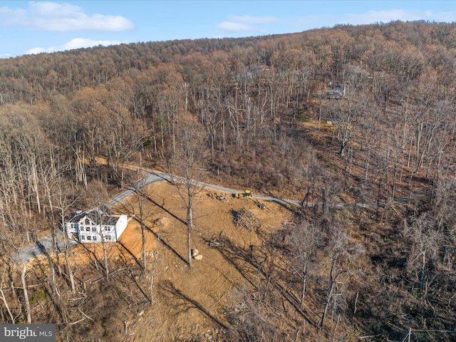 birds eye view of property with a forest view