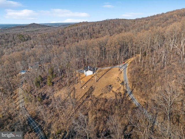 birds eye view of property featuring a view of trees