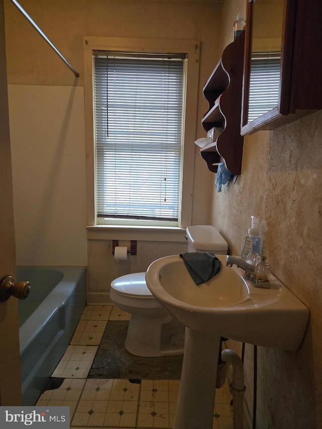 full bathroom with tub / shower combination and toilet