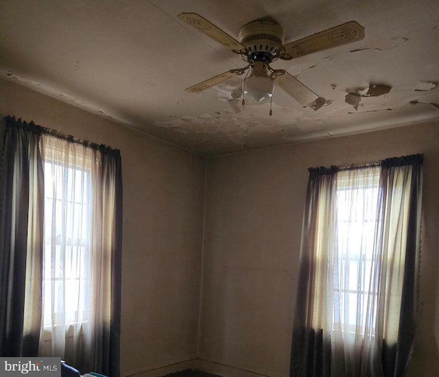 spare room with plenty of natural light and ceiling fan