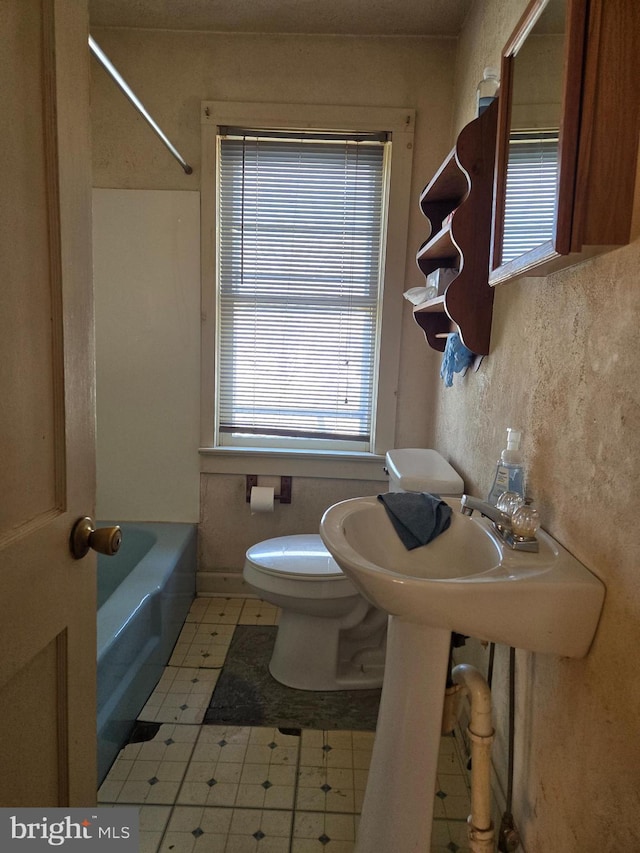 bathroom with toilet and  shower combination