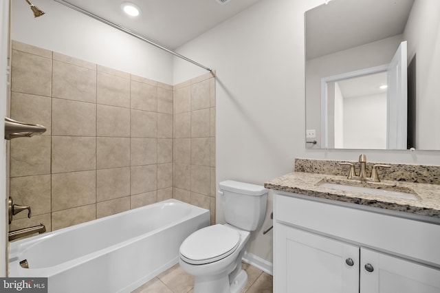 bathroom with tile patterned flooring, bathing tub / shower combination, toilet, and vanity