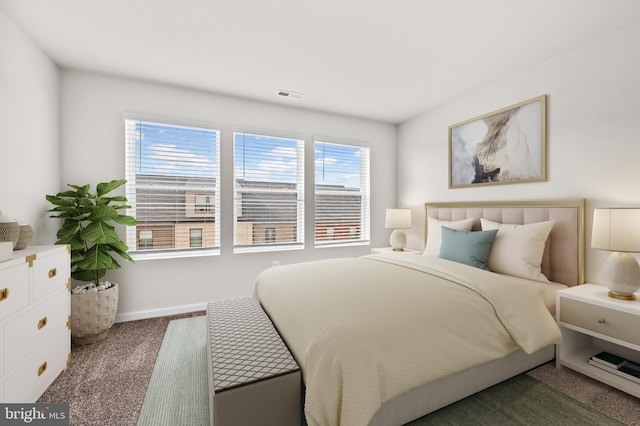 carpeted bedroom featuring visible vents and baseboards