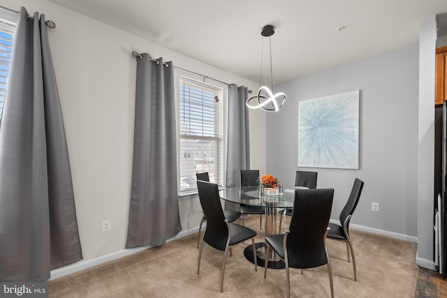 dining room featuring baseboards and carpet floors