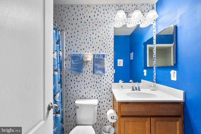 bathroom featuring a shower with shower curtain, toilet, and vanity